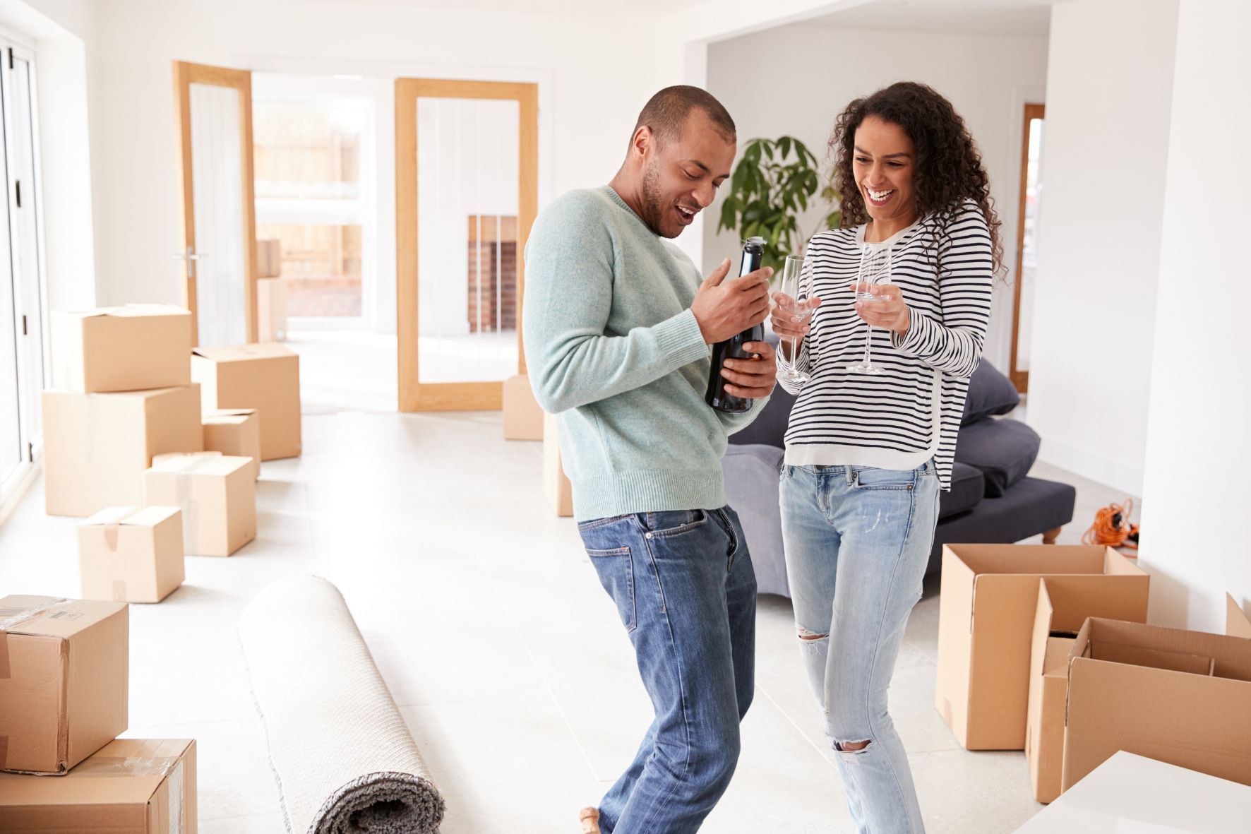 Couple enjoying a celebration drink after moving into new home