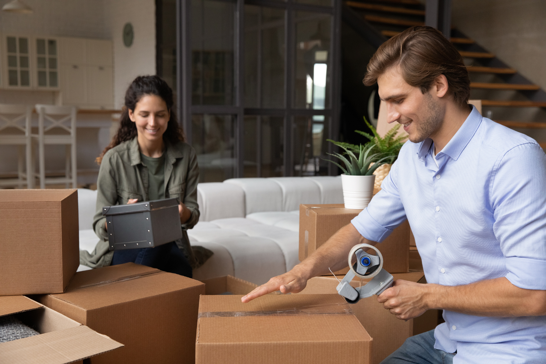 Couple packing up boxes to move into storage