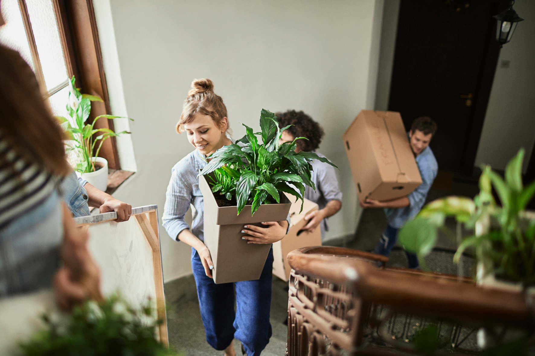 family moving into new home with plants and boxes