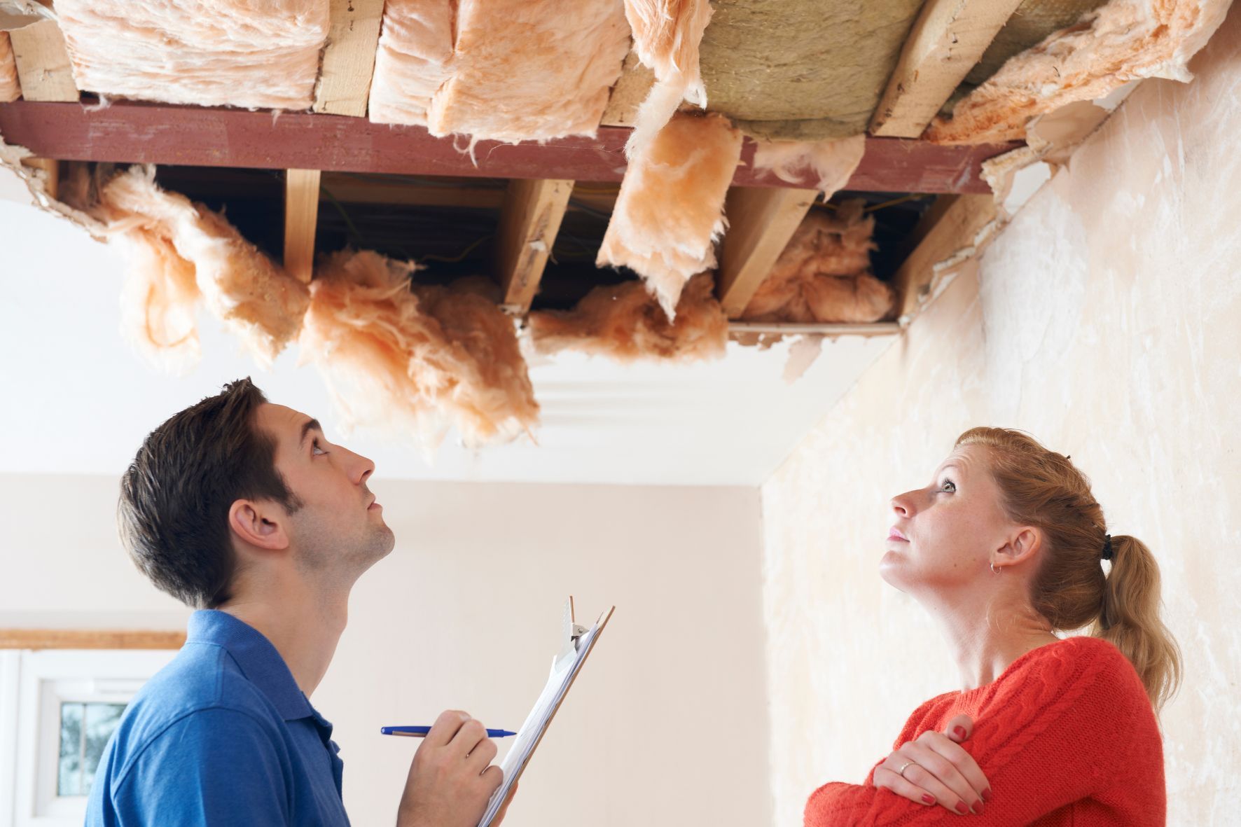 couple assessing water damage in their home