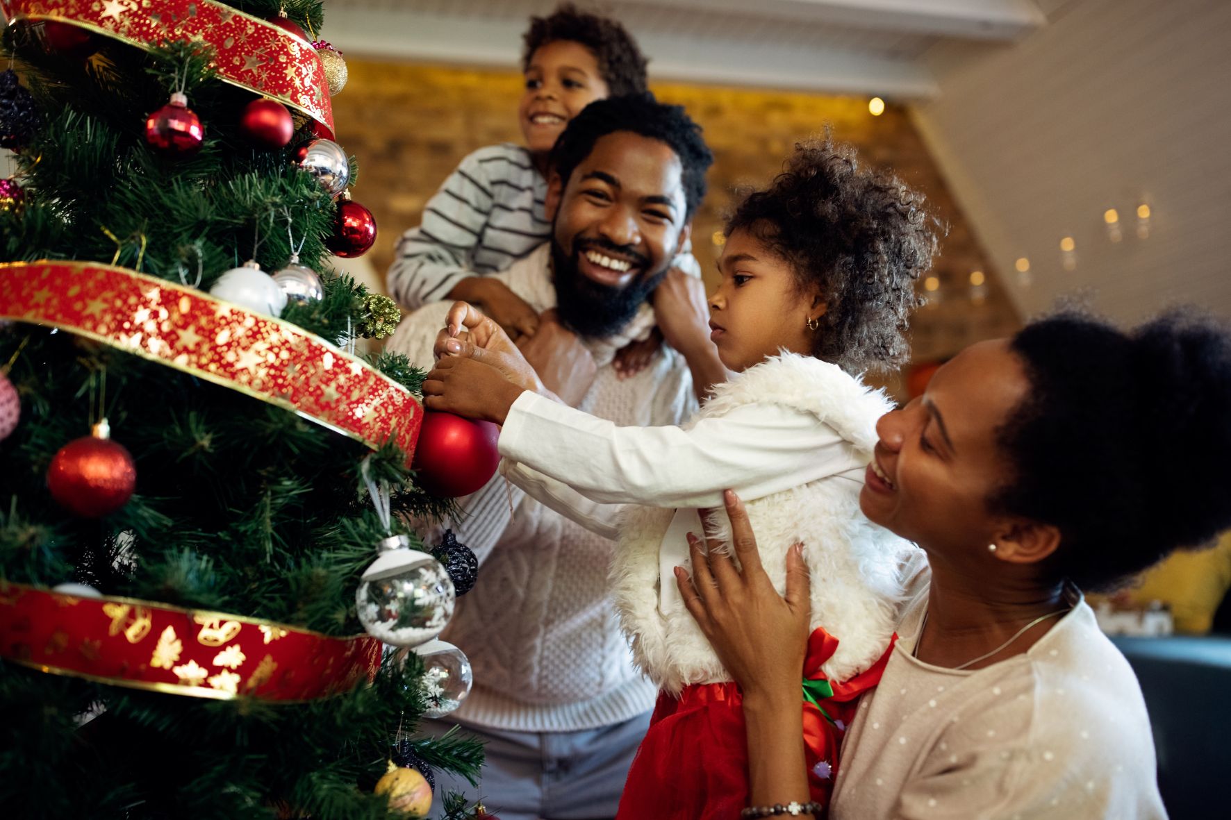 Family decorating christmas tree