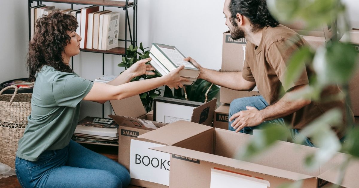 People packing books for a move