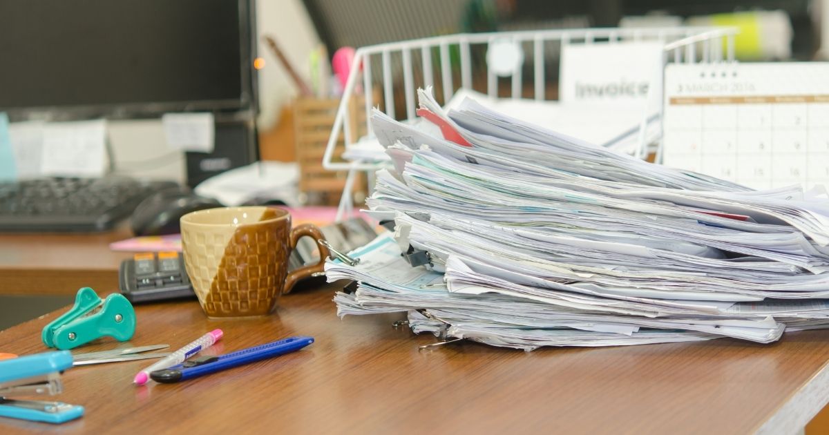 Stack of papers on messy desk